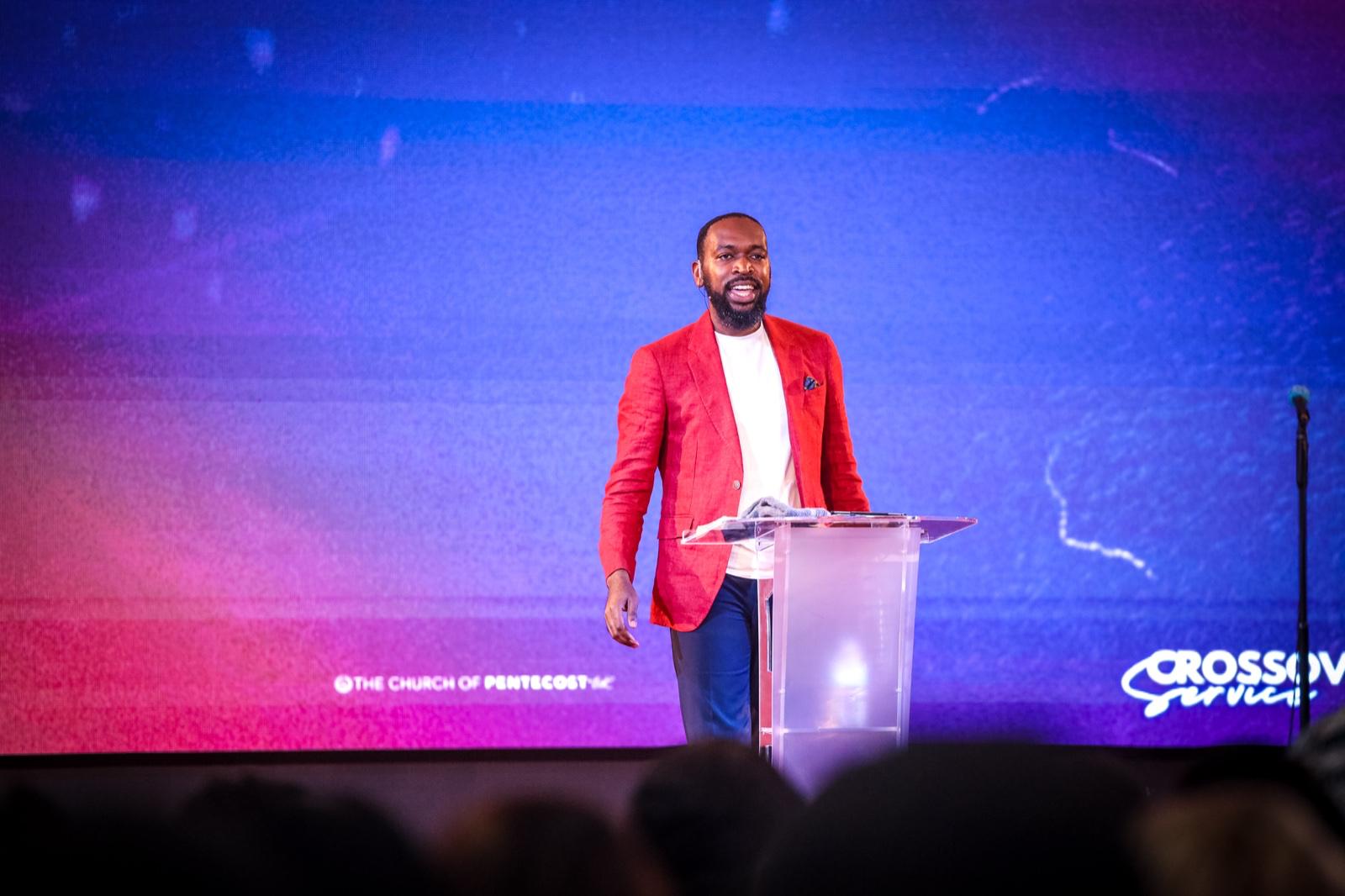 Rev'd Gerald Gyane at the Crossover Service podium